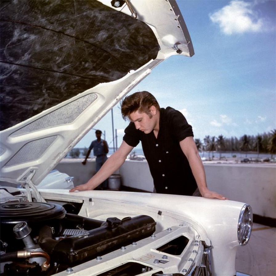 Elvis Presley Examining an Engine for a Lincoln Continental, 1956